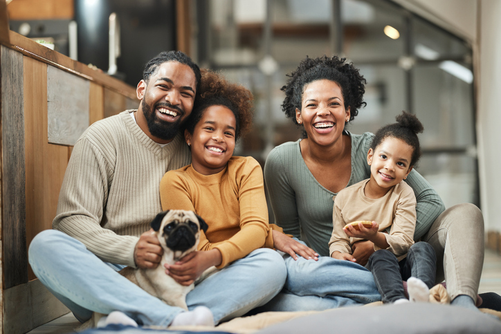 smiling family with dog