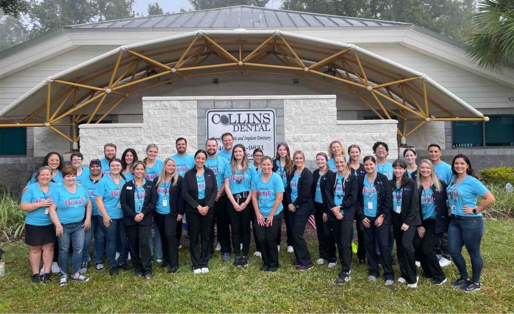 staff photo in front of the exterior of Collins Dental