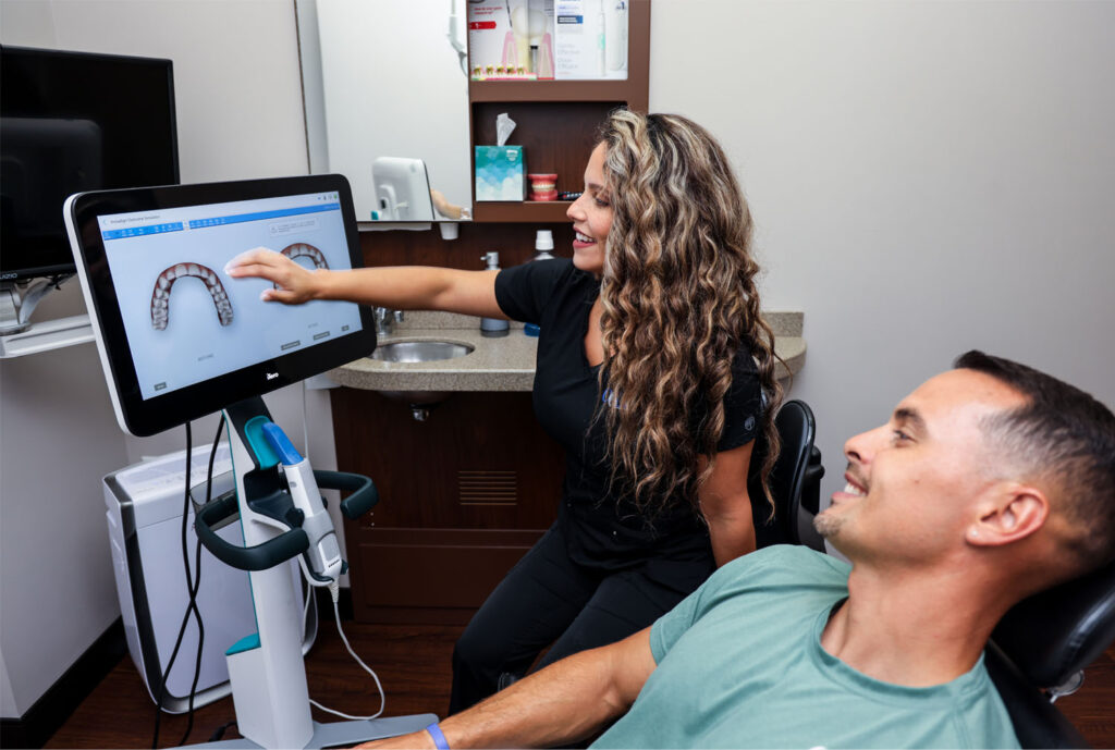 Assistant showing a patient a visual model from a digital scanner